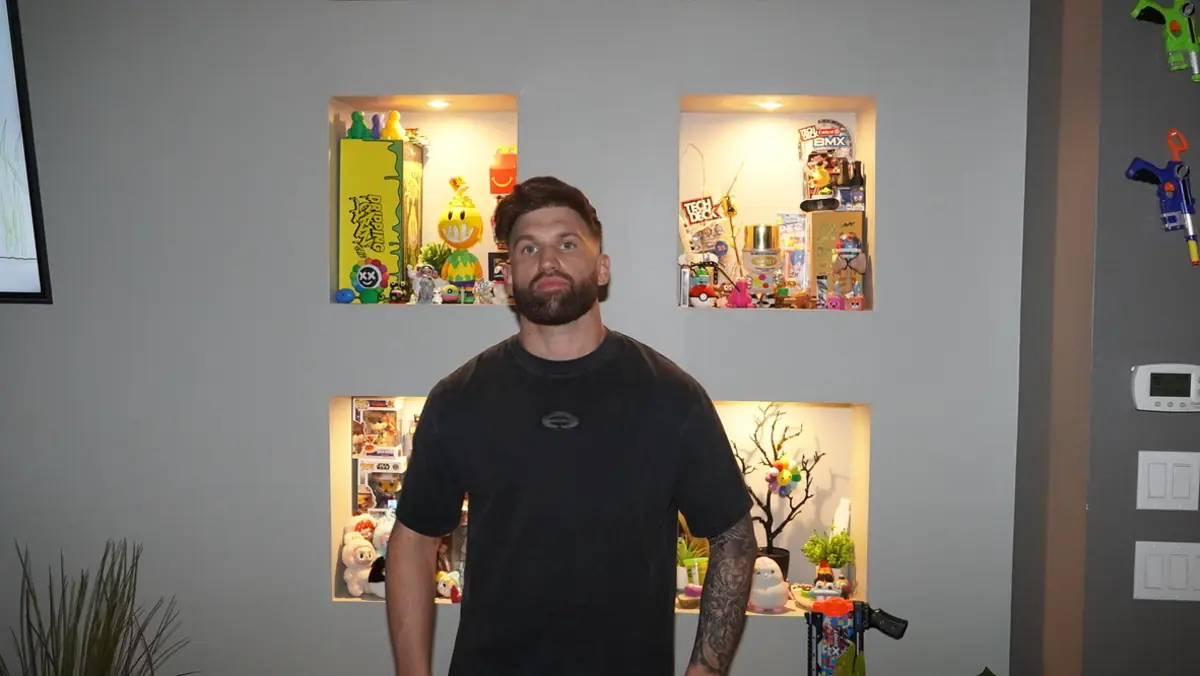 Caleb Hellinger at home in front of a display shelf