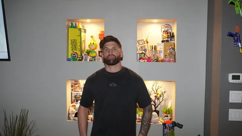 Caleb Hellinger at home in front of a display shelf