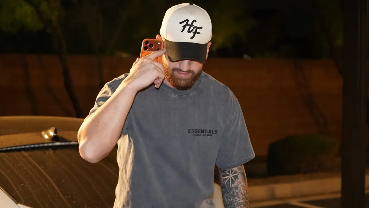 Close portrait of Caleb Hellinger smiling under a cap
