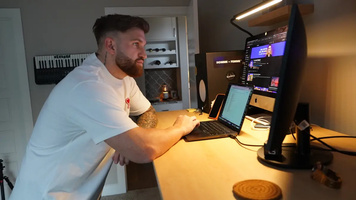 Caleb Hellinger working at his desk in daylight