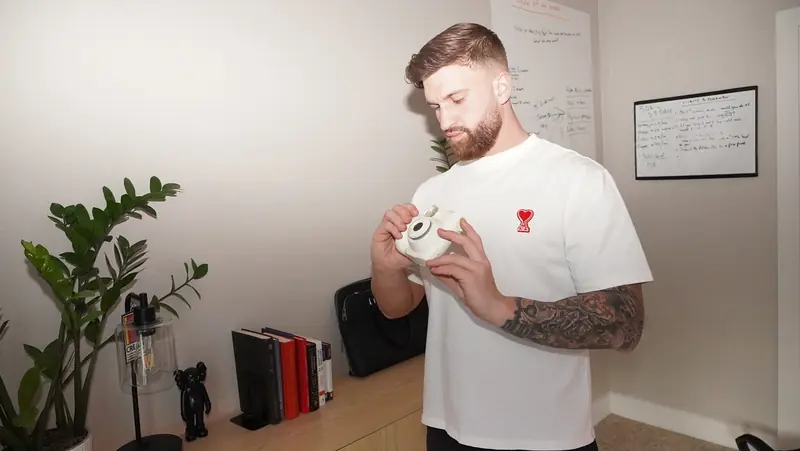 Caleb Hellinger with coffee in his office