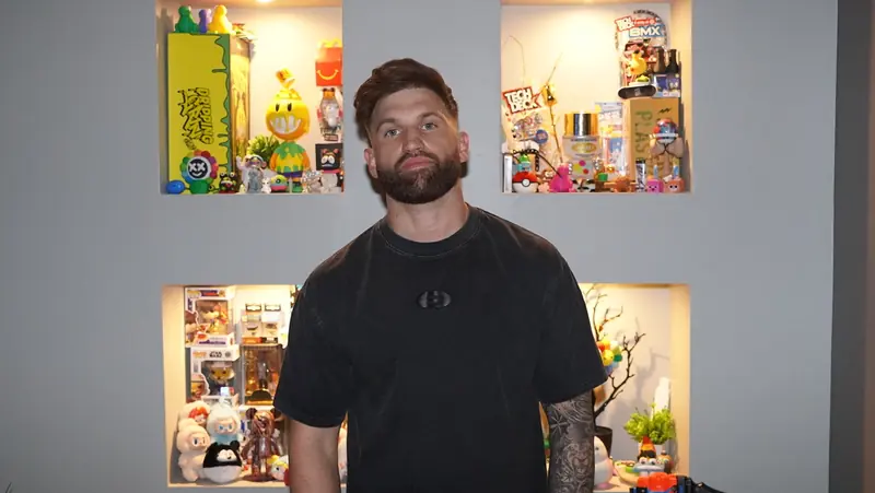Portrait of Caleb Hellinger in a black tee at home