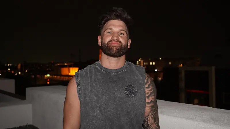 Caleb Hellinger on a rooftop in the evening