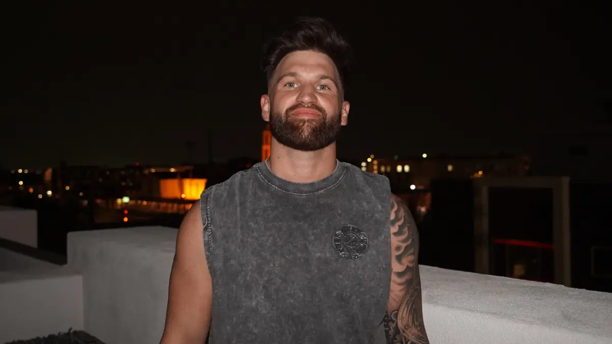 Caleb Hellinger on a rooftop at dusk