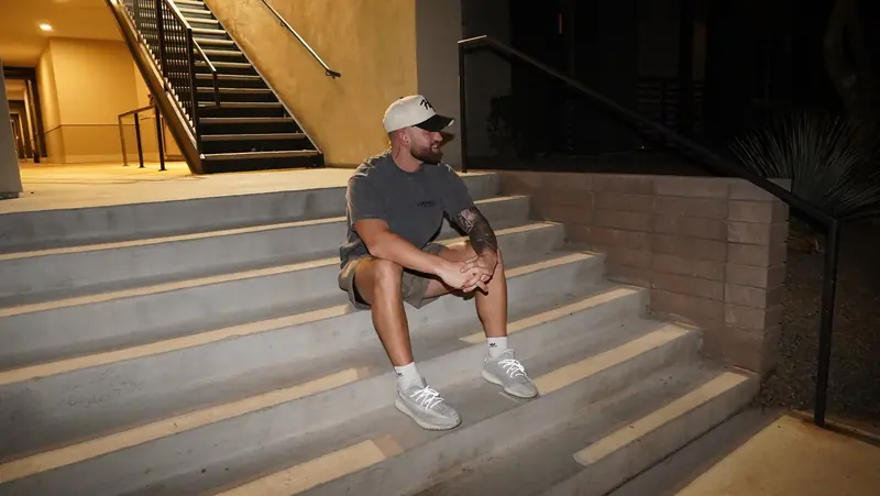 Caleb Hellinger seated on stairs, close crop